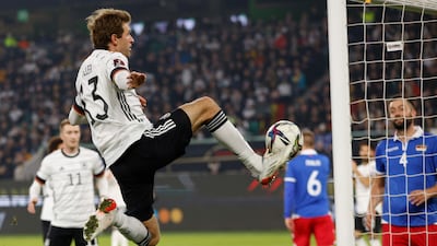 Germany forward Thomas Muller jumps for the ball. AFP