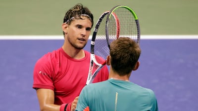Dominic Thiem taps racquets with Alex de Minaur after their US Open quarter-final match. EPA