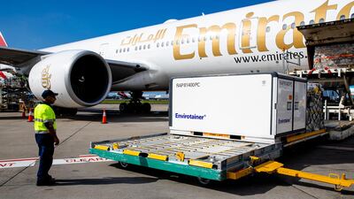 Workers unload the doses from an Emirates aircraft. Getty