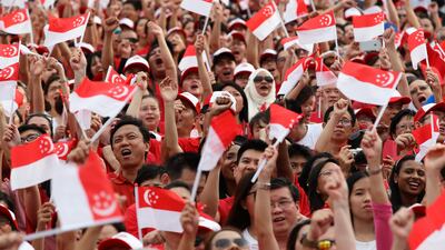 People wave the flags during the National Day Parade at Padang on August 9, 2015 in Singapore. Suhaimi Abdullah / Getty Images