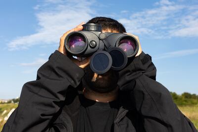 A Channel Rescue volunteer looks out from East Cliff on the southern English coast. Mark Chilvers for The National