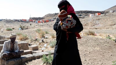 A displaced Yemeni woman holds her baby at a camp for Internally Displaced Persons (IDPs) on the outskirts of Sana'a, Yemen. EPA