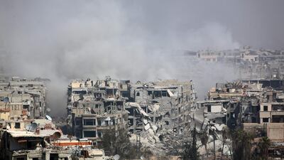 Smoke billows following Syrian government bombardment on the rebel-held besieged town of Harasta, in the Eastern Ghouta region, on the outskirts of Damascus on March 12, 2018. AFP