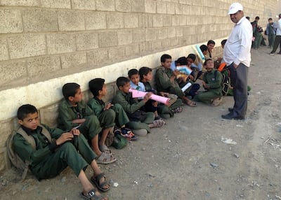 Yemeni children sit outside a school controlled by Houthi rebels. AFP