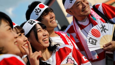 Japanese fans pose for photo as they arrive at Tokyo Stadium. AP Photo