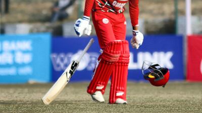 Oman's Aqib Ilyas celebrates his century against Nepal at the Tribhuvan University on Sunday. Subas Humagain for The National