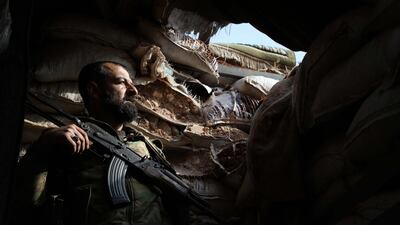 A Syrian rebel-fighter from the National Liberation Front (NLF) takes position on the frontline facing government forces in the al-Rashedin area west of Aleppo in northwestern Syria. AFP