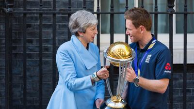 British prime minister Theresa May greets England captain Eoin Morgan as he arrives in Downing Street with the World Cup trophy. EPA