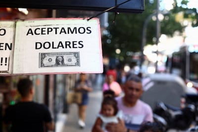 A sign outside a store in Buenos Aires reads: 'We accept dollars.' Reuters