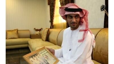 Faisal bin Jumah Al Tunaji at his RAK villa with a newspaper clipping featuring his grandfather. Pawan Singh / The National