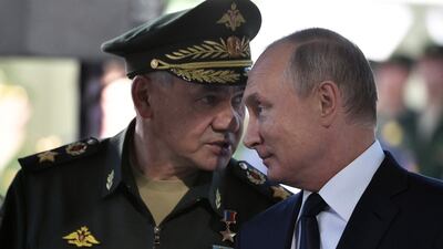 Sergei Shoigu, left, has been replaced as Russia's defence minister under the order of President Vladimir Putin, right. AFP