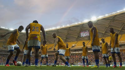 Players from Nacional of Amazonas warm up in the Arena Amazonia Vivaldo Lima before the stadium's inaugural match between the Nacional and Remo on Sunday. Bruno Kelly / Reuters / March 9, 2014