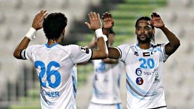 Baniyas's Mohamed Ali Omer, right, greets Yousef Jaber. The team have won their last four games. Jeff Topping/The National)