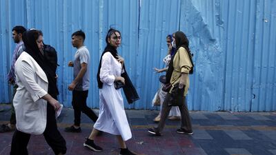 Iranian women, some without the mandatory headscarf, on in a street in Tehran. EPA