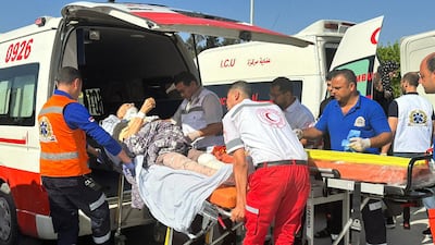 Egyptian paramedics transfer an injured Palestinian to the Egyptian side of the Rafah border crossing from the Gaza Strip. AFP