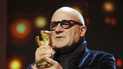 Director Gianfranco Rosi receives the Golden Bear for his film Fuocoammare at the 66th Berlin film festival on Saturday. Fabrizio Bensch / Reuters