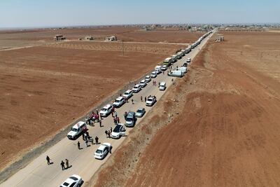 Syrian Red Crescent lorries carrying humanitarian aid arrive at Busra Al Sham in Syria's southern Deraa province before entering Sweida. SANA / AFP