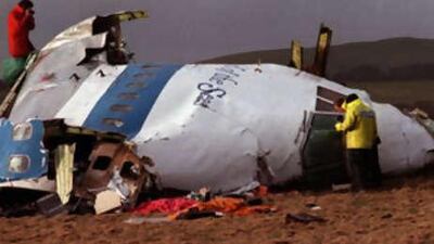 A file photo of police and investigators examining what remains of the flight deck of Pan Am 103 on a field in Lockerbie, Scotland, in this Dec 22 1988. Libya paid $1.5 billion to compensate victims of terrorism.
