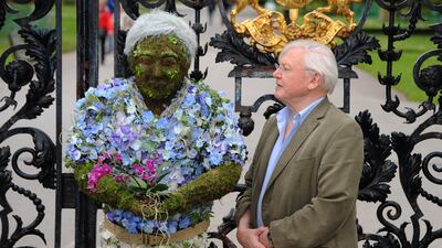 LONDON, UNITED KINGDOM - MAY 17: Sir David Attenborough poses with a floral sculpture of himself outside the Royal Botanical Gardens at Kew Gardens on May 17, 2012 in London, England. The sculpture was created by RHS Chelsea Flower Show Gold Medallist winner Joe Massie. (Photo by Stuart Wilson/Getty Images,)