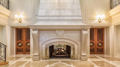 A 24-foot limestone fireplace dominates the vestibule