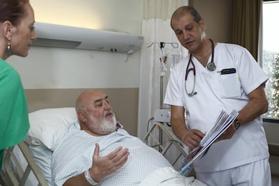Stephen Collins and his daughter Rachael look at test results with Dr Emad Fayyad. Leslie Pableo for The National