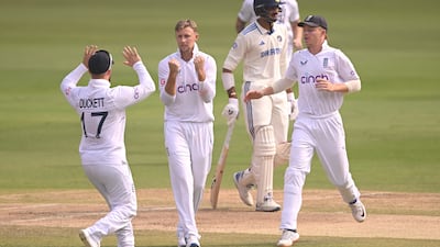England bowler Joe Root celebrates with team mates after taking the wicket of India's Ravindra Jadeja. Getty Images