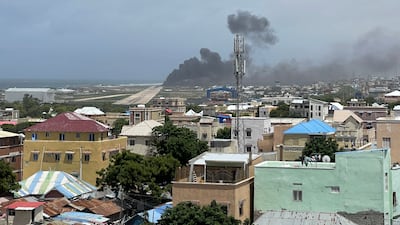 Smoke billows from a plane that flipped over after a crash landing, in Mogadishu, Somalia in this picture obtained from social media. Photo: Abdirahman Mohamed Arab via Reuters
