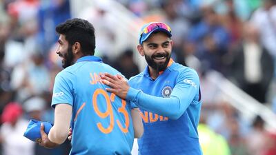 India's captain Virat Kohli, right, celebrates with teammate Jasprit Bumrah after their win over Bangladesh. AP Photo