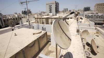Satellite dishes atop a residential building in the Mohammed bin Zayed City area of Abu Dhabi. The capital’s attempts to reduce the numbers of receivers are not working. Christopher Pike / The National