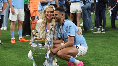 Soccer Football - Champions League Final - Manchester City v Inter Milan - Ataturk Olympic Stadium, Istanbul, Turkey - June 11, 2023 Manchester City's Riyad Mahrez celebrates winning the Champions League with the trophy and his partner Taylor Ward REUTERS / Murad Sezer