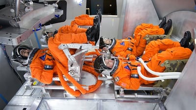 Spacesuit engineers sit in the Orion seats to test the suits the astronauts will wear. Photo: Canadian Space Agency