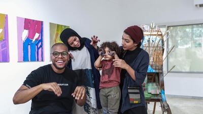 Bait 15 artists Hashel Al Lamki, Afra Al Dhaheri and Maitha Abdalla, who poses with her son, Mubarak. Victor Besa / The National