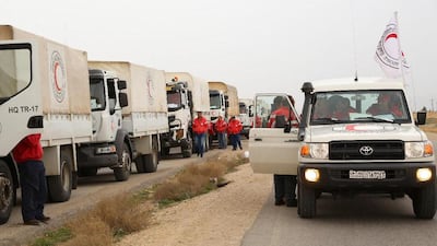 This picture shows an aid convoy of the red crescent arriving at the Rukban desert camp for displaced Syrians along Syria's border with Jordan on February 06, 2019. AFP