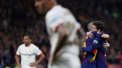 Barcelona's Andres Iniesta hands Lionel Messi the captain's armband as he is substituted off during their Copa del Rey final against Sevilla at the Wanda Metropolitano stadium in Madrid. Susana Vera / Reuters