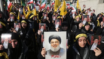 Hezbollah supporters carry pictures of late leader Hassan Nasrallah and Iran's supreme leader, Ayatollah Ali Khamenei, in front of the Iranian embassy in Beirut last month. EPA