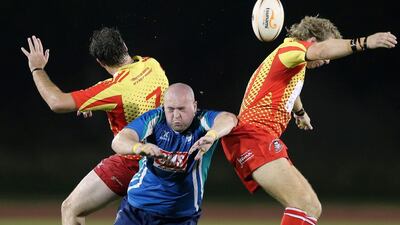 Matt Hutchin, centre, of Abu Dhabi jumps for the ball with David Knight, left, and Daryl Johnson of Dubai. Francois Nel / Getty Images