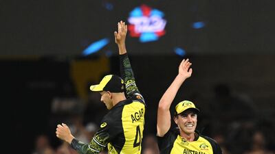 Pat Cummins, right, of Australia celebrates taking the wicket of Ireland captain Andrew Balbirnie. EPA