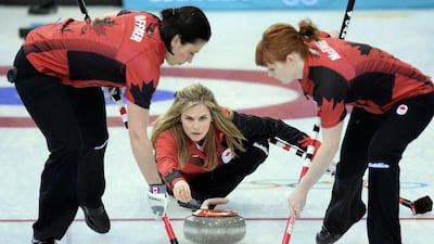 Canada's Jennifer Jones trows the stone as her team mates Jill Officer, left, and Dawn McEwen sweep during women's curling against Russia at the Ice Cube Curling Center on Saturday. Andrej Isakovic / AFP
