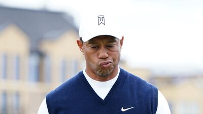 Tiger Woods shows his frustration as he makes his way to the second tee. PA