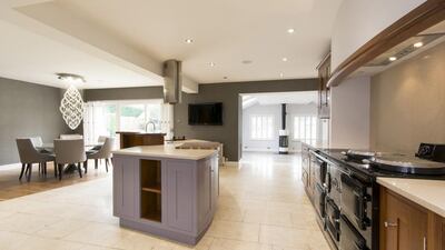 The house sits on a 2,832 square metre plot that also includes front and rear lawns, a greenhouse, children’s play area, a hot tub and a sauna. There is also a thatched garage block on the corner of the plot. Courtesy Savills