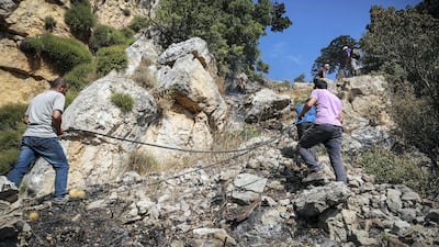 Volunteers climb to the site of a forest fire in Jird Harar, in Lebanon’s Akkar region. Khaled Taleb for The National