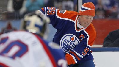 Former Edmonton Oiler Wayne Gretzky looks for the open player against the Winnipeg Jets Alumni during the third period of an NHL Heritage Classic Alumni hockey game in Winnipeg. John Woods / AP Photo