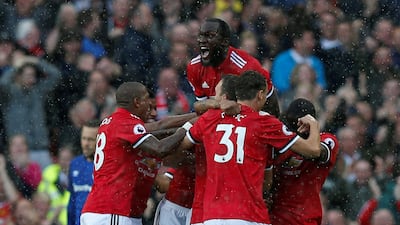 Antonio Valencia is mobbed by his teammates after his early goal in Manchester United's 4-0 win against Everton. Andrew Yates / Reuters