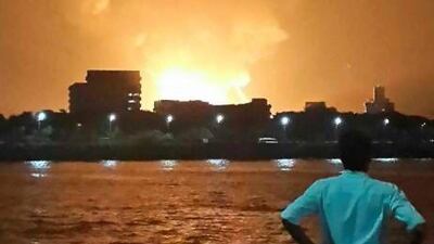 A man watches the INS Sindhurakshak burn in its naval dockyard in southern Mumbai.