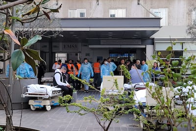 Paramedics wait for the arrival of victims being rushed to a hospital in Beirut. AFP