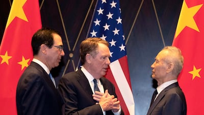 From left, US Treasury Secretary Steven Mnuchin, US Trade Representative Robert Lighthizer and China's Vice Premier Liu He in July last year. On Monday, the three men discussed progress on the first phase of the trade deal that came into force in February. AP