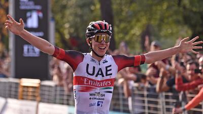 Tadej Pogacar celebrates after crossing the finish line to win the 116th edition of the Giro di Lombardia. EPA