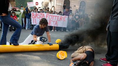 Black smoke billows from a mock gas pipe as young people stage an environmental protest in Milan, Italy. AP Photo