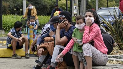 Venezuelan migrants line up to be vaccinated by Bogota's Mayor health personnel in front of an encampment where jobless and homeless migrants are camping during the coronavirus pandemic in Bogota, Colombia. Getty Images