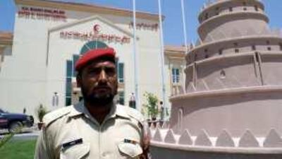 A Pakistani guard stands in front of the hospital named after Sheikh Khalifa bin Zayed Al Nahyan in Muzaffarabad.